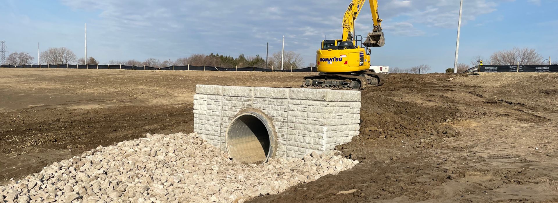 Construction workers installing sewer piping for roads