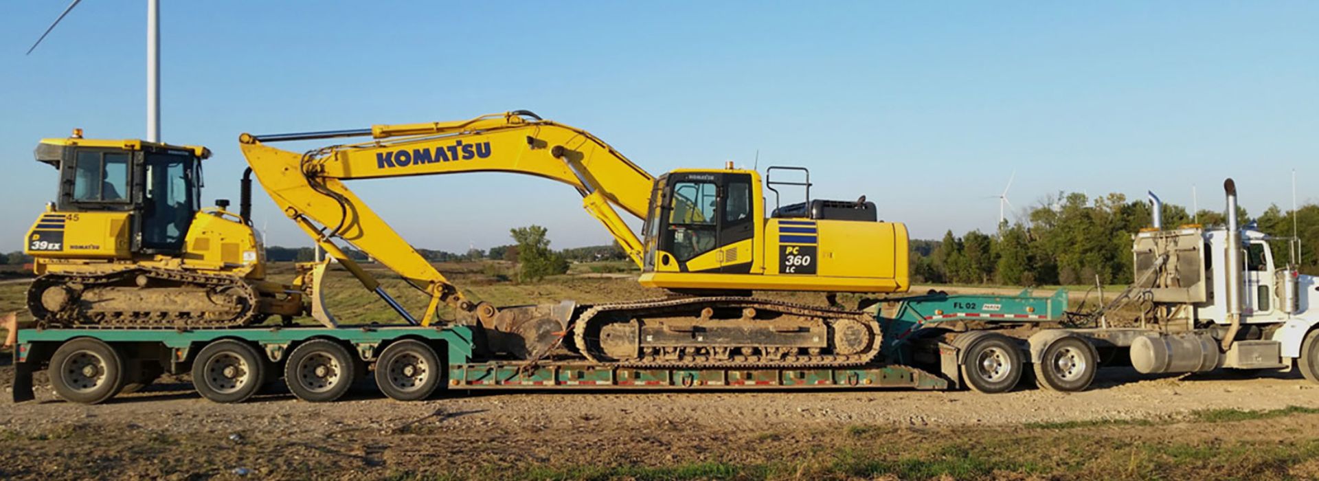 Truck hauling heavy construction equipment