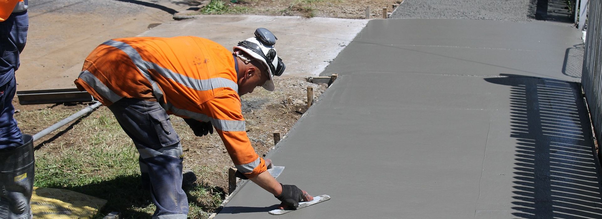 construction worker paving a sidewalk